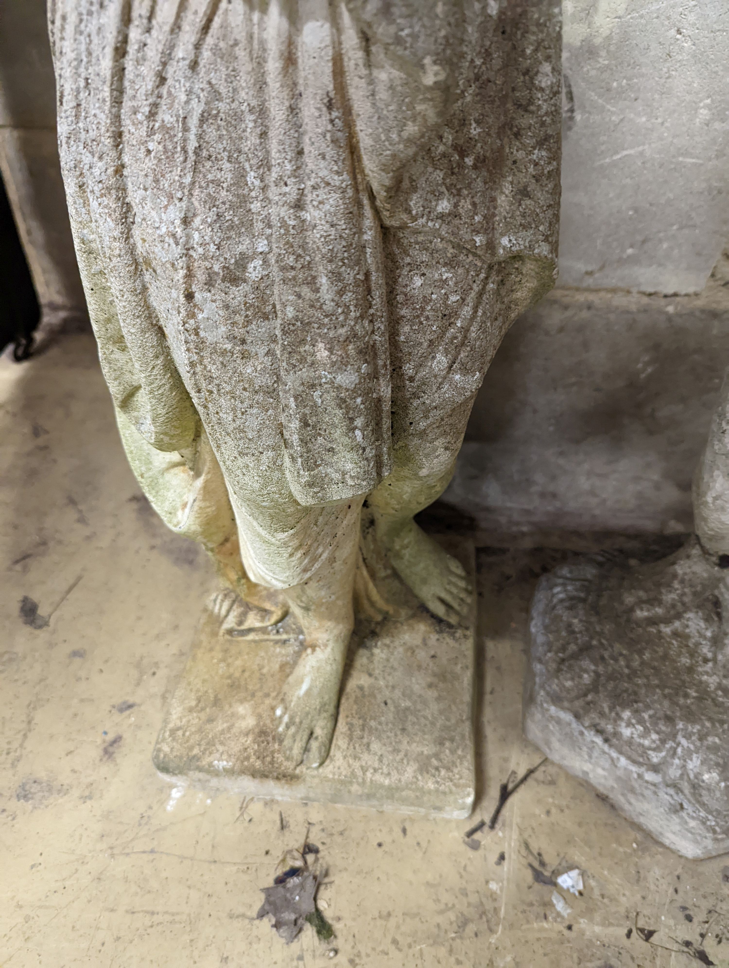 A reconstituted stone garden figure, height 80cm together with a stone figural garden column